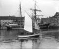 Sailing dinghy between the quays