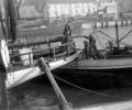 Workmen on board boat at Hamworthy Quay