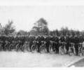 Policemen parading with  bicycles.